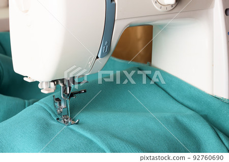 Modern sewing machine and turquoise fabric 92760690