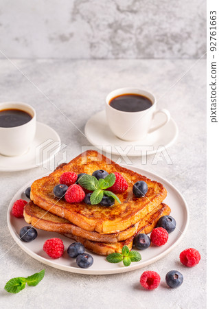 French toast with blueberries, raspberries, maple syrup 92761663