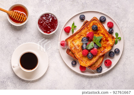 French toast with blueberries, raspberries, maple syrup 92761667