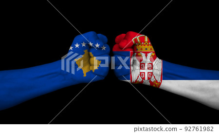 Serbia vs Republic of Kosovo. Two fists with national flags for military conflict. On black background Serbia vs Republic of Kosovo. Two fists with national flags for military conflict. On black background 92761982