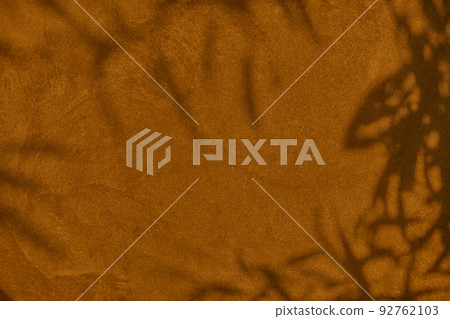 Shadow of leaves on brown concrete wall texture background Shadow of leaves on brown concrete wall texture background 92762103