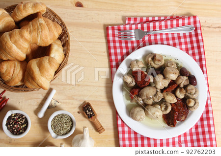 Mushrooms, Sun Dried Tomato, Olives and Capers in Olive Oil on rustic table 92762203