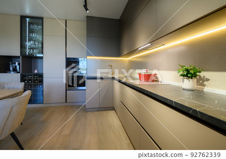 Modern grey luxurious kitchen furniture, closeup to worktop Modern grey luxurious kitchen furniture, closeup to worktop 92762339
