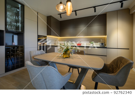Large modern grey luxurious kitchen and dining room in studio apartment Large modern grey luxurious kitchen and dining room in studio apartment 92762340