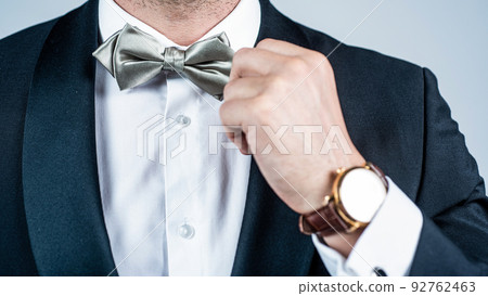 Perfect choice for elegant look. Male hand fix silver bow tie. Fashion accessory. Wedding and prom party. Holiday celebration. Formal event. Festive occasion. Very classy and elegant Perfect choice for elegant look. Male hand fix silver bow tie. Fashion accessory. Wedding and prom party. Holiday celebration. Formal event. Festive occasion. Very classy and elegant 92762463