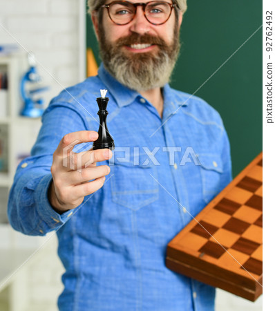 IQ scores. board game. Man playing chess. planning strategy with chess figures. strategy ideas. teacher at tournament. selective focus. strategy concept. management and leadership. queen chess piece IQ scores. board game. Man playing chess. planning strategy with chess figures. strategy ideas. teacher at tournament. selective focus. strategy concept. management and leadership. queen chess piece 92762492