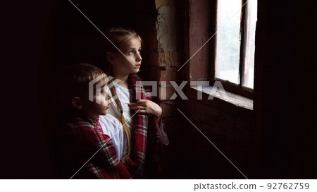 Children stand at the window Children stand at the window 92762759