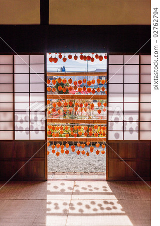 (Yamanashi Prefecture) Former Takano Family Residence (Kanko Yashiki) Persimmons in front of the eaves seen from the tatami room 92762794