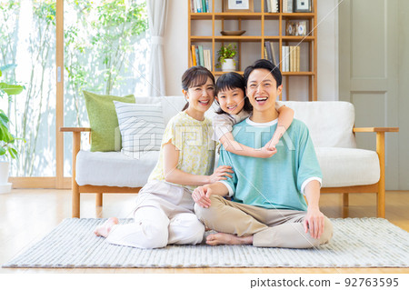 A young family relaxing in the living room A young family relaxing in the living room 92763595