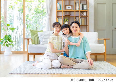 A young family relaxing in the living room A young family relaxing in the living room 92763596