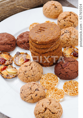 many different types of cookies lay on a plate many different types of cookies lay on a plate 92765054