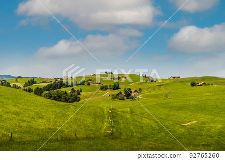 Idyllic mountain landscape in the Swiss Alps with farmhouses and pastures, Switzerland Idyllic mountain landscape in the Swiss Alps with farmhouses and pastures, Switzerland 92765260