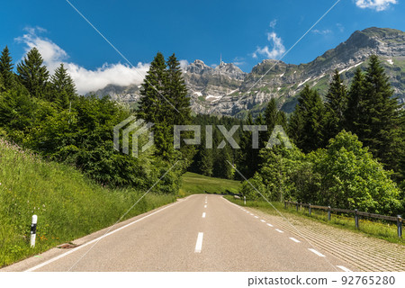 Mountain road in the Swiss Alps with view of the Alpstein massif and Saentis summit, Switzerland Mountain road in the Swiss Alps with view of the Alpstein massif and Saentis summit, Switzerland 92765280