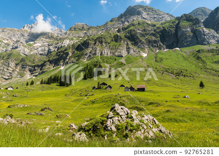 Idyllic landscape in the Swiss Alps with mountain huts and pastures, Switzerland  92765281