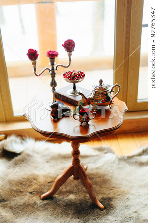 Roses on a table in candlesticks Roses on a table in candlesticks 92765347