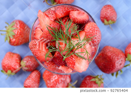 Fresh strawberries on blue tablecloth 92765404
