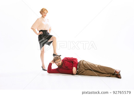 Family couple in vintage outfits sort things out isolated on white background. Concept of relationship, family, feminism, psychology of personality Family couple in vintage outfits sort things out isolated on white background. Concept of relationship, family, feminism, psychology of personality 92765579