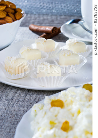 Chocolates in heart shaped white chocolate on the tablecloth 92765758