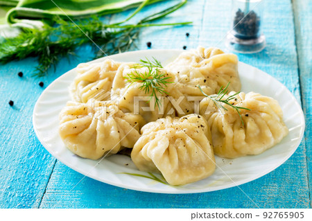 Traditional Georgian khinkali on a wooden table, selective focus. 92765905