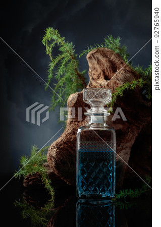 Blue gin and Juniper branches on a black background. Blue gin and Juniper branches on a black background. 92765940
