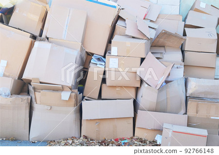 Cardboard and waste paper is collected and packaged for recycling in city. Pile of cardboard is sorting for recycled. Cardboard and waste paper is collected and packaged for recycling in city. Pile of cardboard is sorting for recycled. 92766148