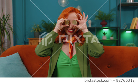 Girl stock trader earning bitcoins after online monitoring trading operations mining hold BTC coins 92766312