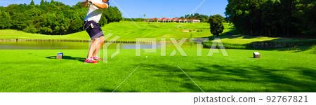 Panorama of the rear view of a man hitting a driver shot over a pond at a golf course (Kisarazu City, Chiba Prefecture) Panorama of the rear view of a man hitting a driver shot over a pond at a golf course (Kisarazu City, Chiba Prefecture) 92767821