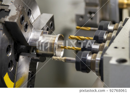 The  CNC multi-tasking machine swiss type  hole drilling the metal cylindrical shape parts. 92768061