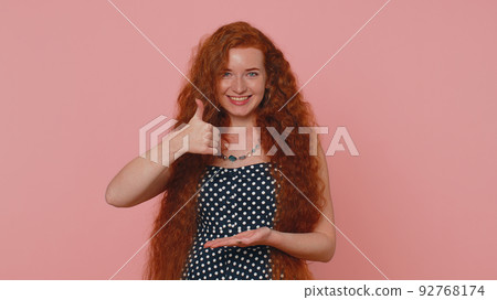 Redhead woman pointing down, saying to subscribe, gesturing ok, like, showing place for information Redhead woman pointing down, saying to subscribe, gesturing ok, like, showing place for information 92768174