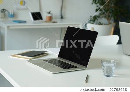 Close-up of workplace of business person with laptop for online work at office Close-up of workplace of business person with laptop for online work at office 92768638