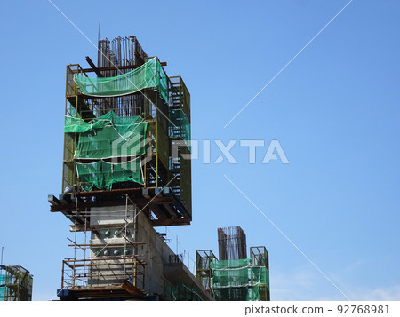 MELAKA, MALAYSIA -JULY 4, 2022: Installation of temporary scaffolding for the construction of tall concrete structures. Safety factors are prioritized to prevent accidents to workers and the public. MELAKA, MALAYSIA -JULY 4, 2022: Installation of temporary scaffolding for the construction of tall concrete structures. Safety factors are prioritized to prevent accidents to workers and the public. 92768981