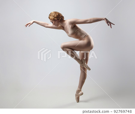 charming ballerina posing in the studio on a white background 92769748