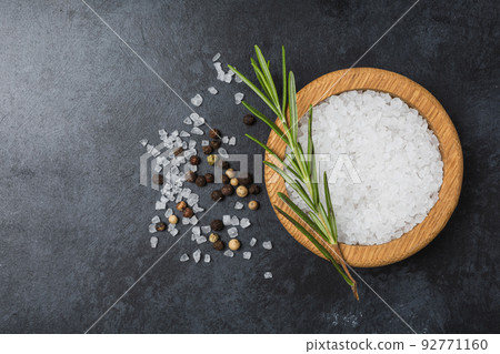 Sea salt in wooden bowl on black table. Sea salt in wooden bowl on black table. 92771160