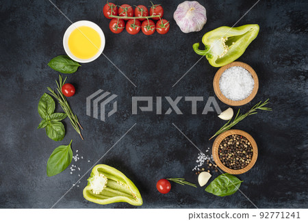 Wooden cutting board and spices, herb for food on black stone table Wooden cutting board and spices, herb for food on black stone table 92771241