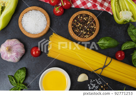 Food background from pasta, spices, herb on black table. 92771253