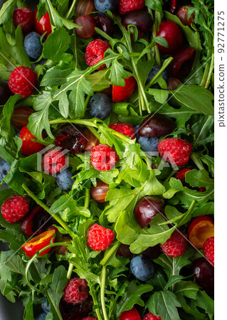 Salad of arugula and fresh berries Salad of arugula and fresh berries 92771275