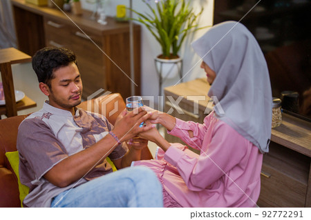 wife waking her husband up in the bed to have a breakfast wife waking her husband up in the bed to have a breakfast 92772291