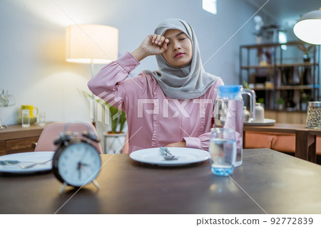 tired woman having break fast or sahur in the morning tired woman having break fast or sahur in the morning 92772839