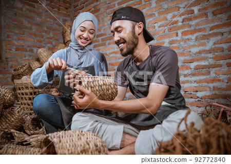 a woman in a hijab and a craftsman weaving handicrafts a woman in a hijab and a craftsman weaving handicrafts 92772840