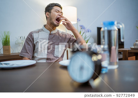 muslim young man having break fast or sahur in the morning muslim young man having break fast or sahur in the morning 92772849