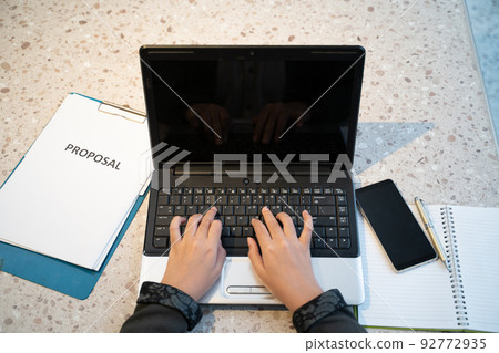 hand typing making a proposal with blank screen laptop hand typing making a proposal with blank screen laptop 92772935