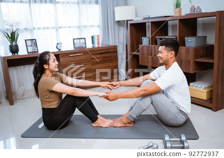 Asian fitness couple, man and woman exercising together at home 92772937
