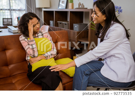 female doctor giving advice during a consultation with female patient female doctor giving advice during a consultation with female patient 92773535