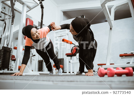 muslim woman with hijab push up and high five workout together muslim woman with hijab push up and high five workout together 92773540