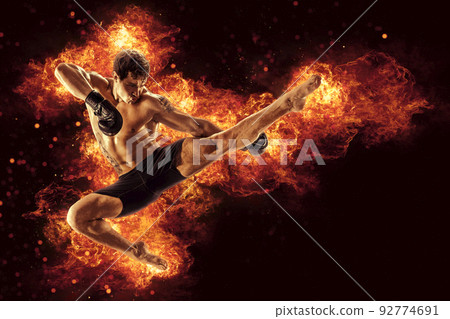 Fighter man punching in fire. MMA fighter 92774691