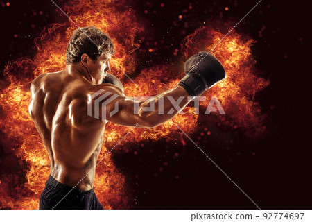 Fighter man punching in fire. MMA fighter 92774697
