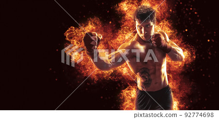 Fighter man punching in fire. MMA fighter 92774698