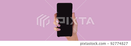 Womans hand with lavender manicure holding smartphone with blank screen 92774827