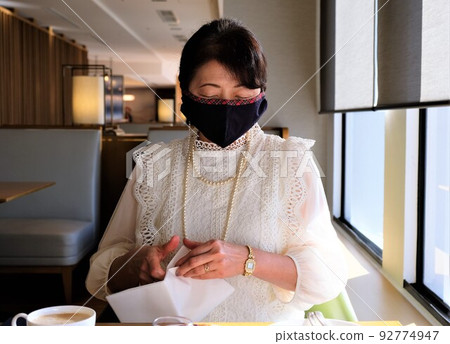 一名戴面具的女士在酒店休息室參加下午茶時間 一名戴面具的女士在酒店休息室參加下午茶時間 92774947