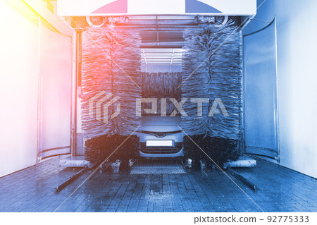 Car washing automatic carwash. Brush washer clean blue auto car on automatic car wash station. Carwash cleaning service. 92775333